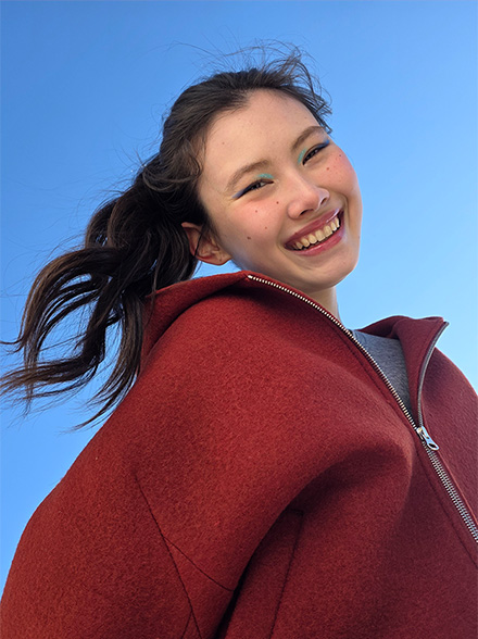 Portrait of a woman taken outdoors. Lighting is precise and subject's features are accurate.